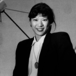 Susan Yee in front of a satellite dish 